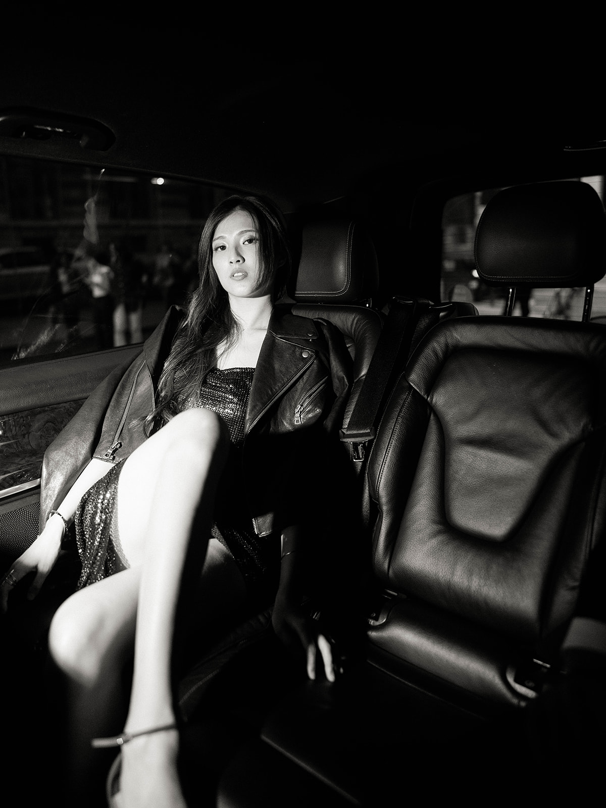 Black and white editorial engagement portrait inside a luxury car in Paris at night